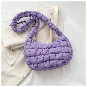 Detail of purple quilted bubble bag featuring soft padded nylon and cloud texture