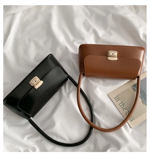 Vue à plat de sacs noirs et marrons minimalistes avec des boutons dorés
