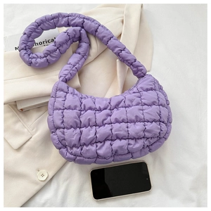 Detailed texture of light purple quilted cloud hobo bag on a stylish blazer