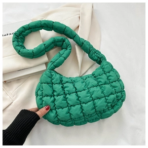 Macro detail of vibrant green quilted bubble bag featuring 3D puff texture and padded strap