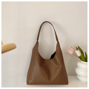 Close-up of vintage brown faux leather hobo tote bag featuring a smooth texture and large capacity
