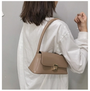 Vue arrière du sac baguette vintage kaki porté à l'épaule montrant la taille et le style