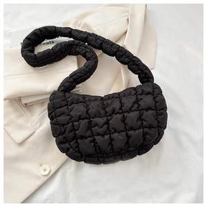 Detailed close-up of a black quilted puffer bag featuring a unique cloud-like texture