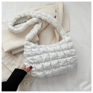 Detailed view of white quilted puffer shoulder bag with soft textured bubble fabric
