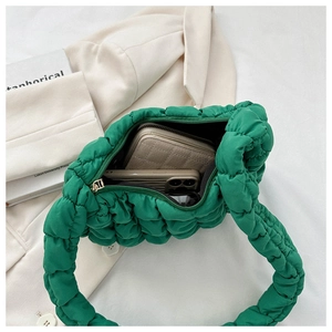 Spacious interior of a green quilted cloud bag showing room for phone and wallet