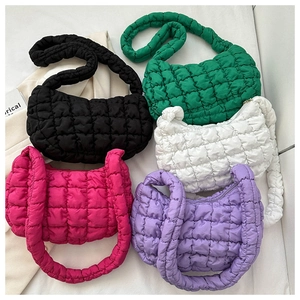 Macro detail of quilted bubble puffer bags in five vibrant colors with soft texture