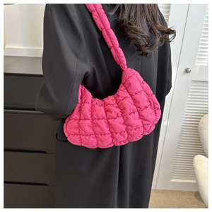 Detail of rose red quilted cloud bag showing puff texture and lattice stitching