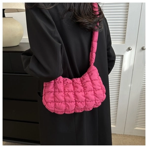Detail of rose red quilted cloud bag with padded texture and bubble nylon fabric