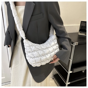 Modern white quilted cloud bag shown on model with chic office style and casual aesthetic