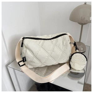Dettaglio della borsa a tracolla trapuntata beige con portamonete e tracolla regolabile