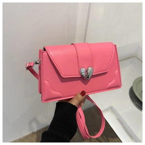 Detail of pink PU leather handbag showing a silver heart-shaped metallic buckle buckle