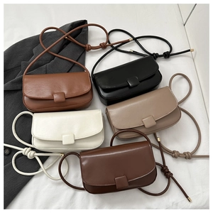 Flat lay of PU leather saddle bags in five matte colors with knotted rope strap details