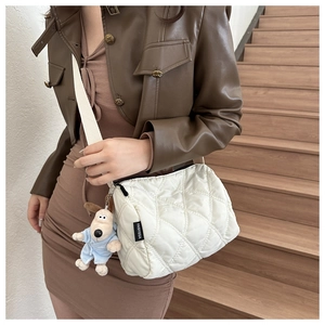 White quilted nylon shoulder bag with woven strap and cute plush dog charm accessory