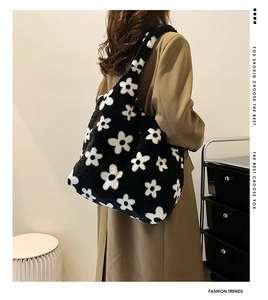 Close-up of plush faux fur tote bag with black and white floral pattern texture