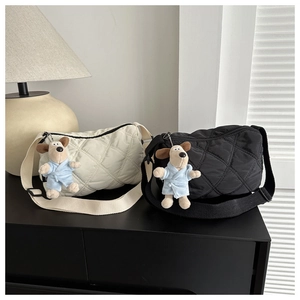 Quilted nylon crossbody bags in black and white with cute plush puppy bag charms