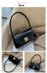 Détail du sac à bandoulière rétro noir avec fermoir doré poli et finition lisse