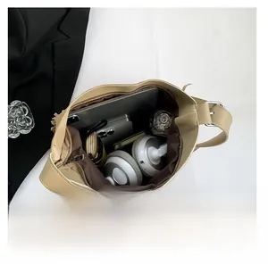 Internal view of a beige tote bag showing capacity for tablet, headphones, and wallet