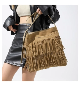 Detail of khaki suede tote bag featuring multi-layer fringe tassels and adjustable strap