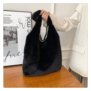 Detail of soft black faux fur tote bag showing the plush texture and spacious handle design