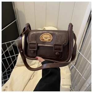 Détail d'un sac bandoulière en cuir PU marron avec patch brodé en forme de chiot mignon
