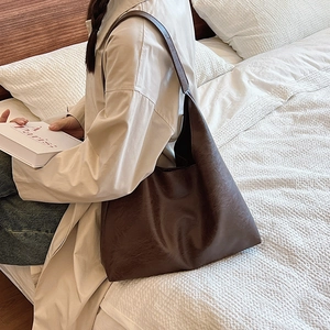 Minimalist large brown tote bag in pebbled PU leather shown on a lifestyle setting