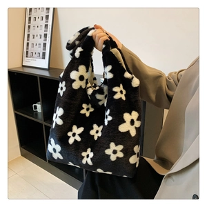 Detail of soft plush tote bag featuring large black and white floral pattern texture