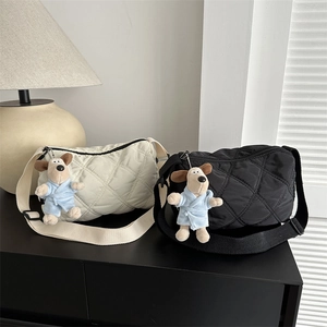 Quilted nylon crossbody bag in cream and black with cartoon dog pendant and wide strap