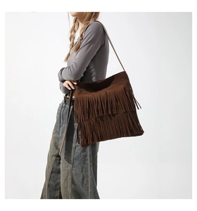 Close-up of brown suede tote bag with double-layered long fringe and retro bohemian style