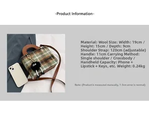 Detail view of plaid wool handbag featuring leather handle and black plush pompom charm