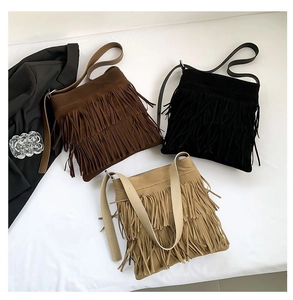 Detailed overhead view of boho fringe tote bags in dark brown, black, and beige suede