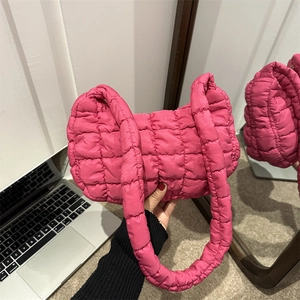 Stylish pink quilted cloud bag featuring a puffer square texture and matching shoulder strap