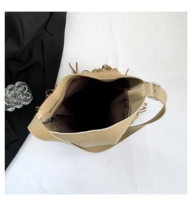 Top view of beige tassel tote bag interior with dark lining and zipper closure