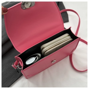 Rose pink minimalist leather crossbody bag showing interior space and magnetic closure