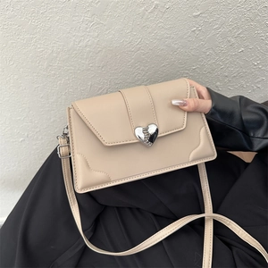 Beige heart-buckle crossbody bag with minimalist rectangular flap design for women