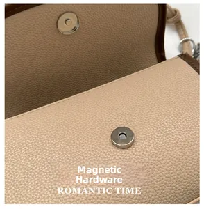 Detailed macro view of silver magnetic clasp on beige lychee leather crossbody bag