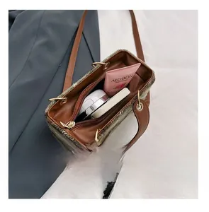 Detail view of plaid wool bag interior showing storage space for daily cosmetics