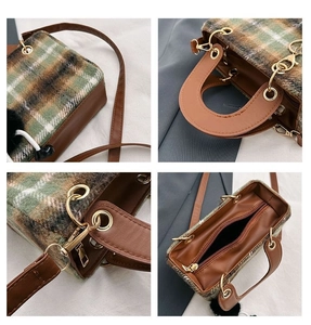 Detail view of plaid wool bag with gold hardware, leather handle and detachable strap