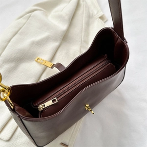 Dark brown leather underarm bag featuring a gold zipper closure and metal lock detail
