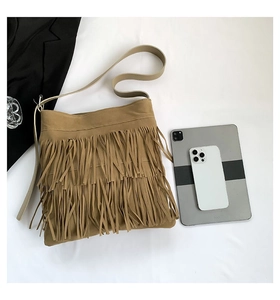 Brown tassel tote bag with fringed layers shown next to a tablet for size reference