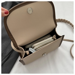 Interior view of beige cross-body bag holding a long wallet and large smartphone