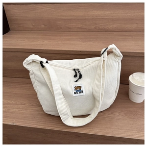 White corduroy crossbody moon bag with cartoon bear patch and black adjustable strap
