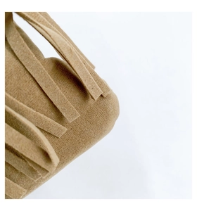 Macro shot of khaki suede tote bag showcasing high-quality fringe tassels and soft texture