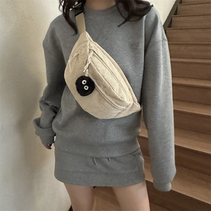 Minimalist beige corduroy crossbody chest bag for women with plush black pendant accessory