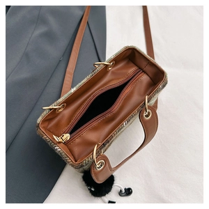 Detailed top view of open tweed crossbody bag with leather interior and zipper