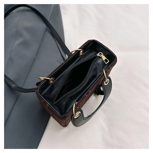 Top view of plaid woolen crossbody bag with black leather handles and inner compartment