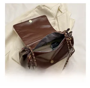 Interior view of brown leather tote showing capacity for umbrella and notebook