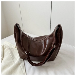 Detailed view of the deep brown PU leather bag showing adjustable strap and silver buckle
