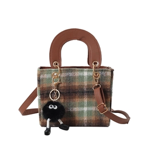 Vintage plaid wool handbag in green and brown with leather handle and monster charm