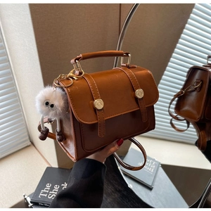 Brown vintage PU leather mini bag with metal buckle and white furry monster charm