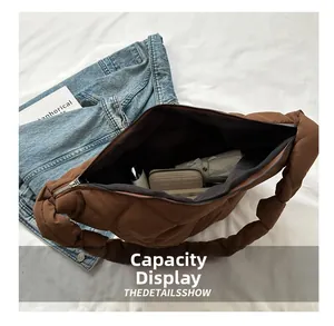 Interior view of brown quilted bag showing large capacity for wallet and umbrella